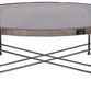 Round Calliope Cocktail Table with curved apron and cross-base metal frame with a dark glass top and metallic finish