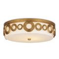 Angled side view with black background highlighting brass finish and circular frame design