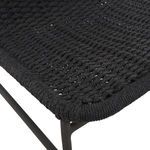 Close-up of woven seat edge tightly wrapped with dark grey rope on metal frame