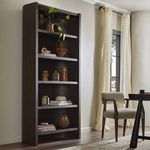 Lockhart Bookcase styled with decorative pottery and books in a bright room with cream curtains
