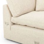 Detailed seam and zipper on the bottom edge of the back cushion next to the arm’s metal bracket