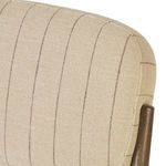 Close-up of top corner of chair’s cushioned back showing pinstripe detail and smooth curve