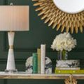Close-up of Fossey Object with books and white floral arrangement on console table, highlighting color contrast