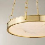 Close-up of aged brass frame edge and alabaster diffuser showing stepped detailing