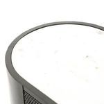 Rounded end detail focusing on clean gunmetal metal surface extending to the marble top