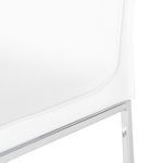 Close-up of white seat upholstery stitching and polished chrome frame of Colter Counter Stool