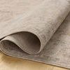 Louisa oatmeal rug rolled at one corner highlighting soft velvety texture and backing material