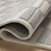 Detail of Bradley rug fold revealing thickness and plush high-low wool pile texture