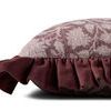 Side view showing thickness and ruffled edge detail of plum purple pillow