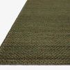 Angled edge view of Lily Green Rug emphasizing thickness and hand-woven texture against a neutral background