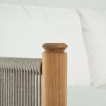 Detailed view of smooth natural teak post with carved top corner on loveseat arm