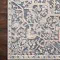 Close-up of Lucia Rug corner on wood floor showing intricate pattern detail and color contrast