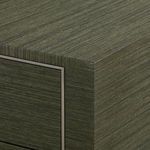 Close-up showing textured grasscloth surface and champagne-gilded ribbon detail on the corner