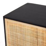 Close-up corner showing woven cane door panel edge and black Mango wood frame
