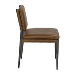 Side profile displaying thick padded leather cushions and slender powder-coated steel legs