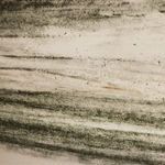 Close-up of textured horizontal lines and shading representing land in painting