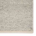 Detailed close-up showing tight weave and cream-colored border on rug edge