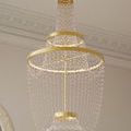 Close-up angle showing LED-lit gold rings and hanging glass beads from below the chandelier
