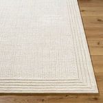 Tight close-up of corner highlighting the layered border texture and woven wool fibers