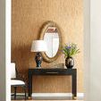 Ella Armchair placed beside black side table with lamp and gold mirror on textured tan wall