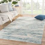 Heaston Abstract Rug styled in bright room with light wood floor, white sofa, and blue throw pillow