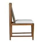 Side profile showing Pacifica chair’s light teak frame, white cushion, and taupe rope backrest