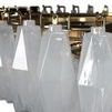 Close-up of faceted opaline glass prisms showing clasp details and reflective brass frame