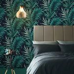 Yasuni Wallpaper installed on bedroom wall behind taupe upholstered bed with pendant light and dark bedding
