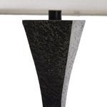 Side angle close-up of textured forged metal tapered floor lamp base