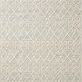 Hand-woven ivory rug with textured geometric pattern and fringe accents