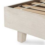 Close-up of footboard corner and tapered leg in light-finished mango wood