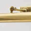 Detailed close-up of brass adjustment knob on picture light arm