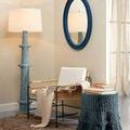 Rowan Floor Lamp styled in a living room with chair, table, and blue oval mirror on wall