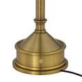 Close-up of the power button with small lit red charging indicator on brass base