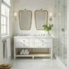 Sienna table styled in bright bathroom under paired rope-framed mirrors and sconces with towels on lower shelf