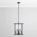 Chandelier hanging in a room with light gray walls and white ceiling molding