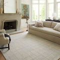 Francis Silver / Sky Rug styled in bright living room with beige sofa and fireplace