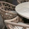 Multiple Dana Rope Dining Chairs angled under white dining table showing woven sides and seat cushions
