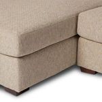 Detail of seat cushion seam and section where chaise connects to sofa base