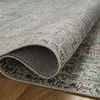 Close-up showing folded edge of Jules Emerald rug to reveal smooth polyester pile texture and backing