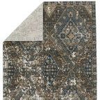Back side of rug flipped to reveal lighter woven underside with muted pattern