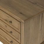 Angled close-up of nightstand top and side, showing wood texture and molding detail