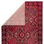 Rug flipped to show light-colored polypropylene backing with visible pattern from front