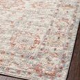 Angled corner view of Estelle Ivory Rust rug showing muted color palette with rust accents and delicate floral motifs