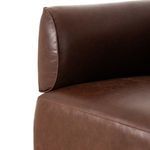 Close-up detail of chair arm resting on seat cushion with visible stitching