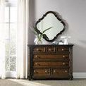 Leesburg Bureau styled in a room setting with large decorative mirror above and plants on top