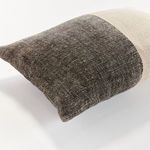 Close-up showing border seam detail where charcoal and beige sections meet on Jules Pillow
