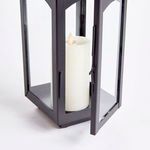 Close-up of lantern door slightly open revealing candle inside and door latch detail