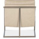 Back view showing vertical stainless steel frame supports and beige leather upholstery without cushions visible