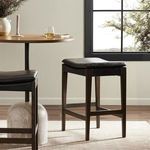 Close-up of Aya Stool's oak legs and footrest bars highlighting grain and finish